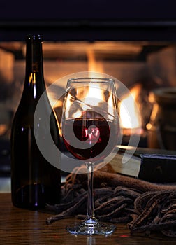 Glass of wine with fireplace in background