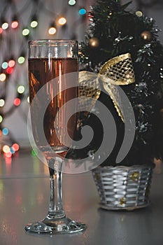 Glass of wine on garland christmas background