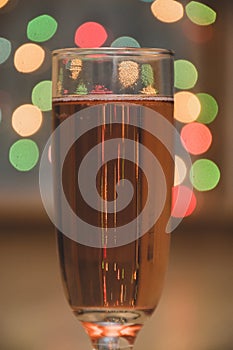 Glass of wine on garland christmas background