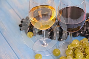 Glass of wine, grapes on a blue background