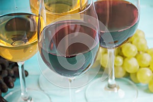 Glass of wine, grapes on a blue wooden background