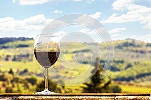 Glass of Wine on a Ledge Overlooking Vineyards in Chianti Italy