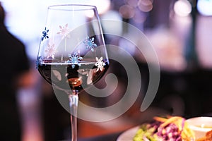 A glass of wine ornamented with snowflakes  for Christmas celebrity