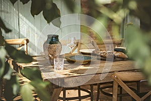 Glass on wooden table under sun