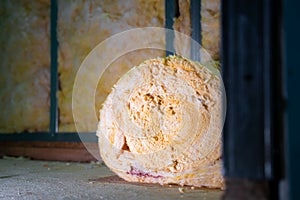 Glass wool in a roll on the floor while filling the cavities between the metal profiles. Drywall soundproofing material