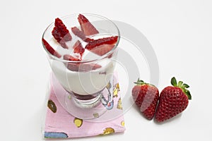 Glass of yogurt with strawberries photo