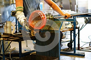 Glassblower shaping a vase