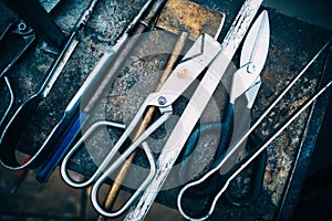 Glassblowing tools table background : forceps, tweezers, scissors , blowing pipes