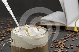 Glasse coffee, drink mix of cold coffee and ice cream. Coffee beans and notebook