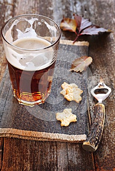 Glasse of light beer, crackers and beer bottle opener