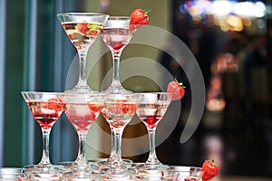 Glasses with alcohol drinks in pyramid
