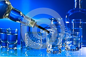 Glasses with alcoholic drinks on a glass table in bar