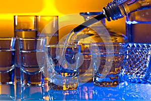 Glasses with alcoholic drinks on a glass table in bar