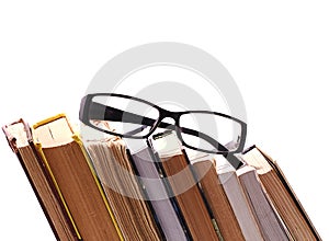 Glasses on the background of books