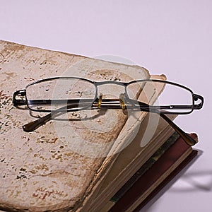 Glasses on the background of books