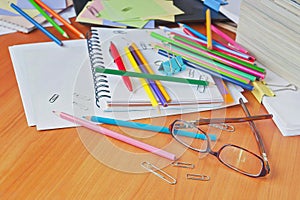 Glasses on the background of colored pencils and paper.