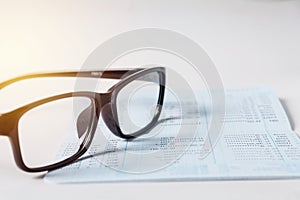 Glasses with bank account passbook for savings financial and accounting concept.