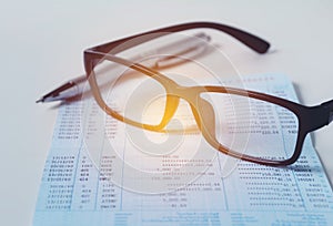 Glasses with bank account passbook for savings financial and accounting concept.