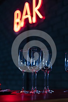 Glasses on bar neon