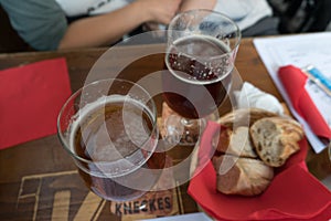 Glasses of beer and bread on the table in a bistro in Strasbourg