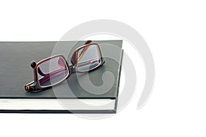 Glasses and black notebook isolate white background