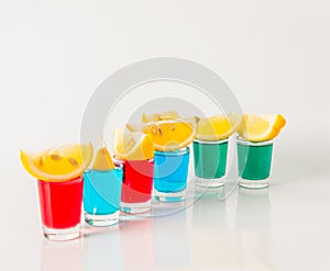 Glasses with blue, green and red kamikaze, glamorous drinks, mix