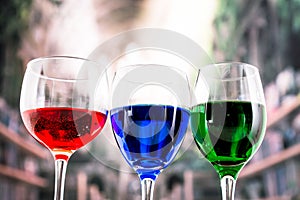 Glasses with blue red and green liquid cocktails