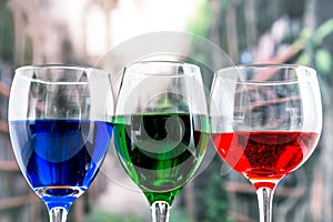 Glasses with blue red and green liquid cocktails