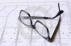 Glasses and blueprints