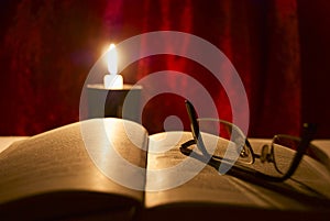 Glasses, book and candle