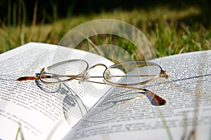 Glasses on a book with grass