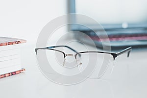 Glasses with book and laptop