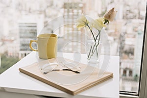Glasses book near flowers mug table. High quality and resolution beautiful photo concept