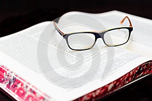 Glasses on the book of Talmud. Background Torah study photo