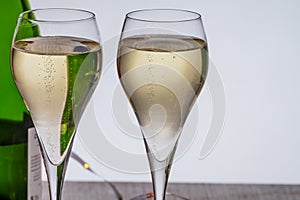 Glasses of bubble wine champagne, cremant, cava or prosecco and christmas stars for decoration
