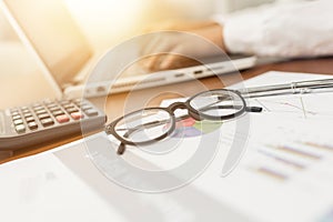 Glasses on business document photo
