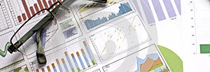 Glasses and calculator on paper table with finance diagram