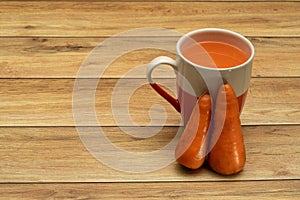 Glasses of carrot juice with vegetables on table close up