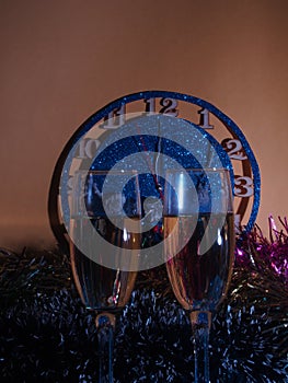 Glasses with champagne on the background of the clock. The clock