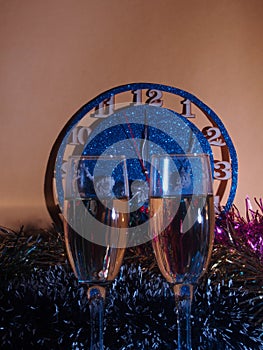 Glasses with champagne on the background of the clock. The clock