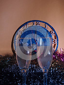 Glasses with champagne on the background of the clock. The clock