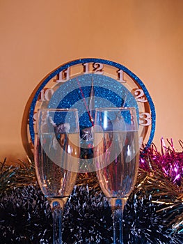 Glasses with champagne on the background of the clock. The clock