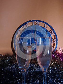 Glasses with champagne on the background of the clock. The clock