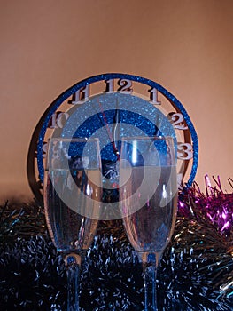 Glasses with champagne on the background of the clock. The clock