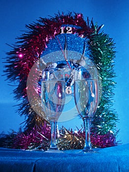 Glasses with champagne on the background of the clock. The clock