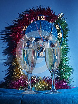 Glasses with champagne on the background of the clock. The clock