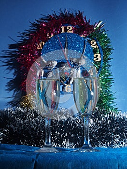 Glasses with champagne on the background of the clock. The clock