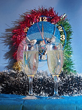 Glasses with champagne on the background of the clock. The clock