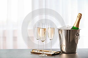 Glasses with champagne and bottle in bucket
