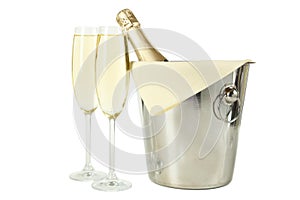 Glasses of champagne with bottle in a bucket on white